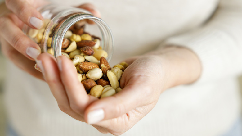 Person pouring nuts into a hand