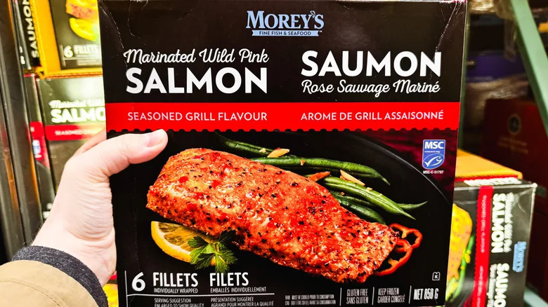 Person holding Morey's Fine Fish and Seafood Marinated Wild Pink Salmon