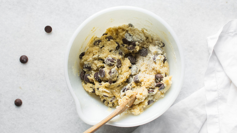 Overhead view of chocolate chip dough in a white bowl
