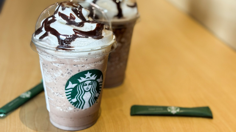 Two Starbucks Frappucinos on a wooden table