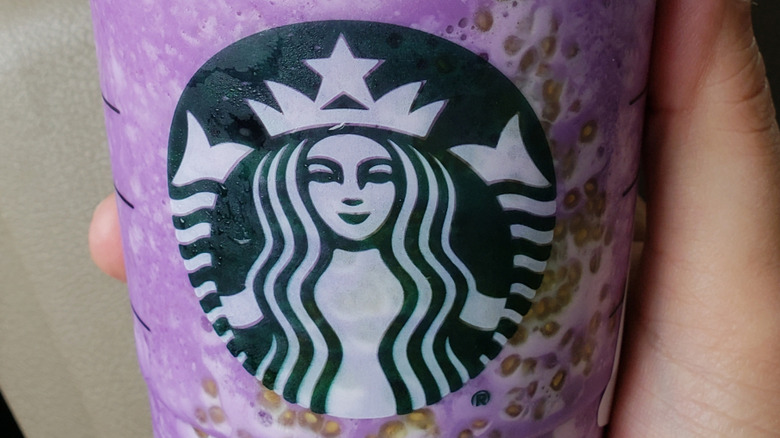 A purple Starbucks drink with greenish seeds