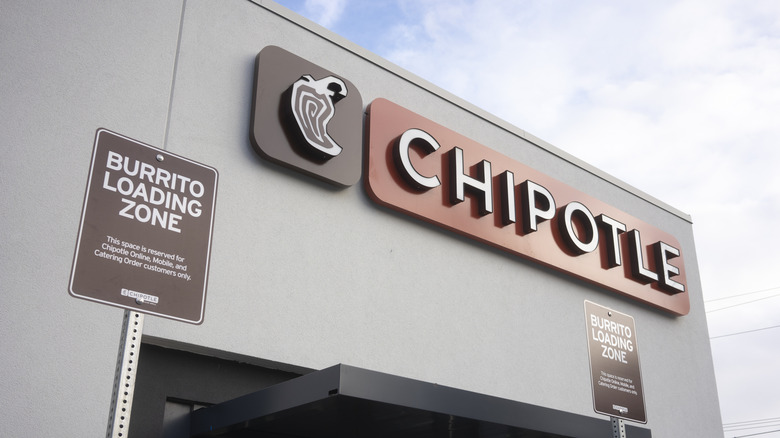 The exterior of a Chipotle restaurant showing the burrito loading zone signs