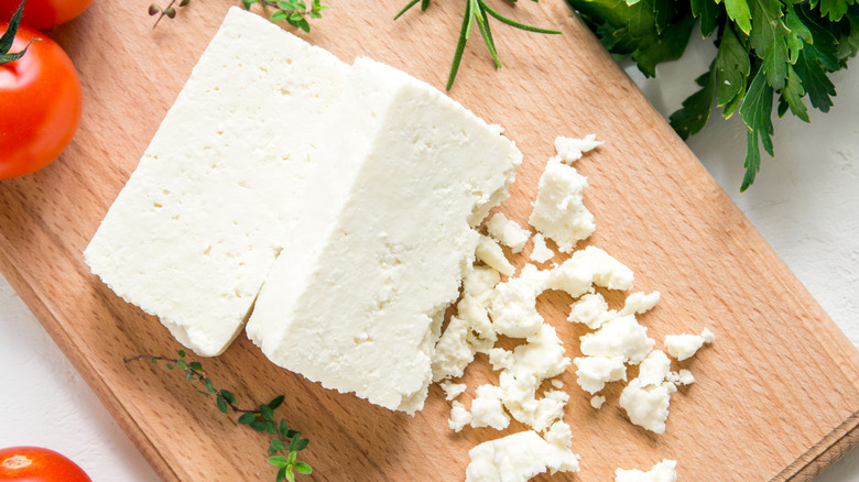 block of feta cheese on wooden board