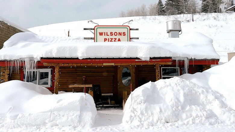 Exterior of snow-covered Wilsons Pizza in Wyoming