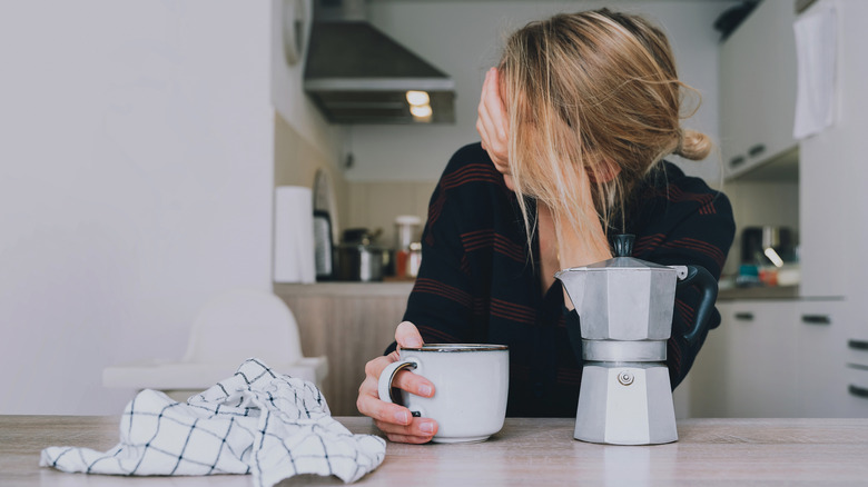 Woman sitting at table with coffee