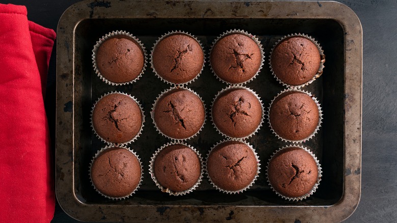 Muffins on dark baking sheet