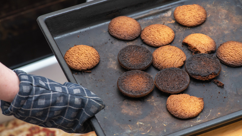 Burnt cookies on black pan