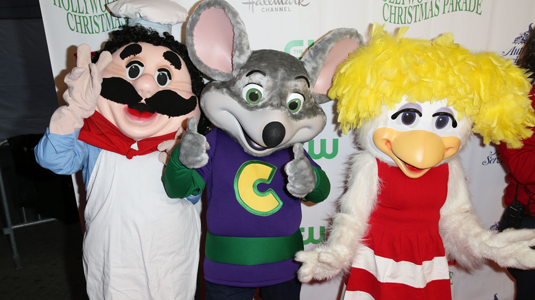 Pasqually, Chuck E. Cheese, and another mascot posing for a photo