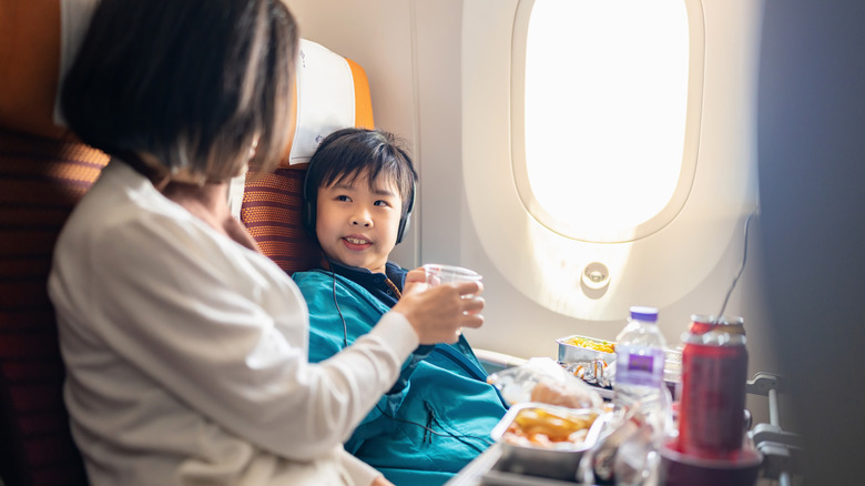 Two people eating airplane food
