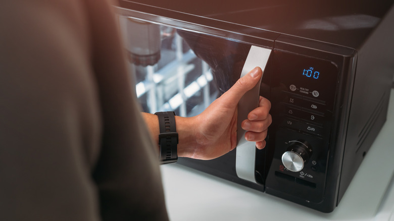 A person using a microwave