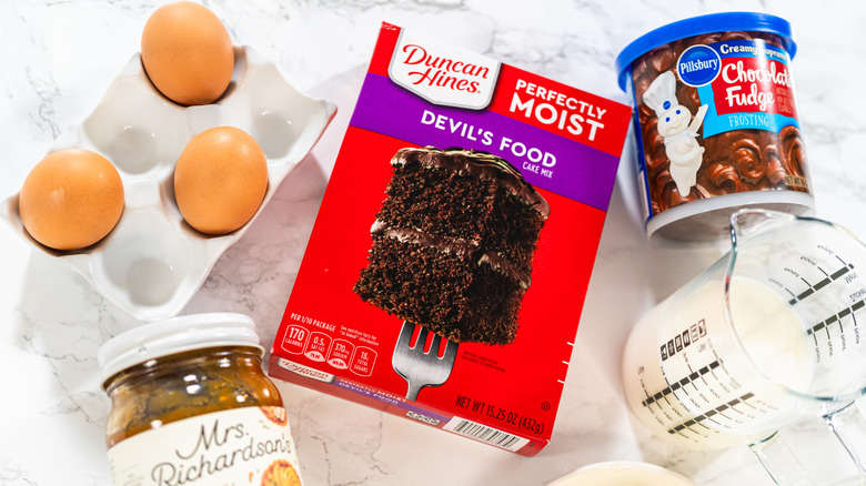 Boxed cake mix and required ingredients arranged together on a counter