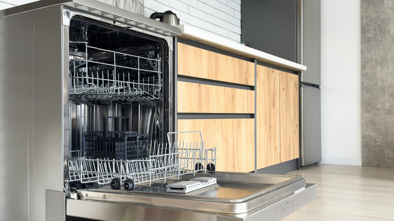 empty, open dishwasher in a kitchen