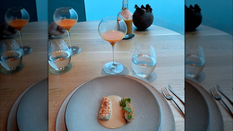 Bowls of seafood dishes served at Under on a blue table