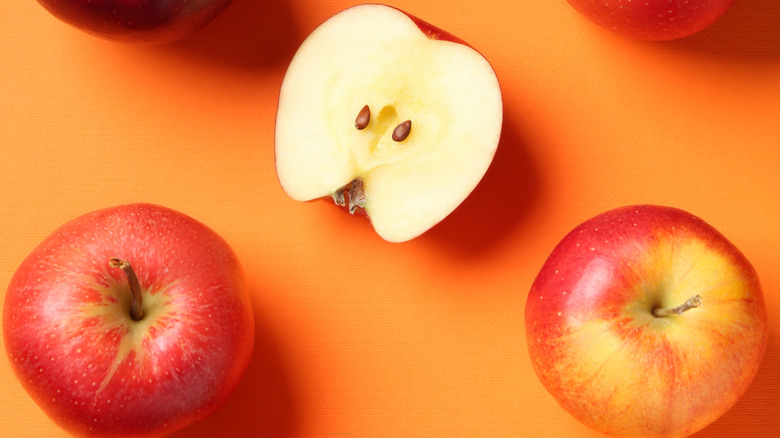 sliced apples on an orange background