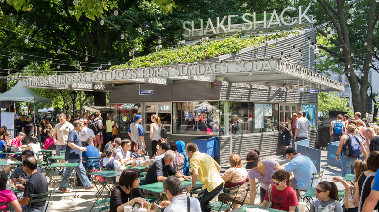 Shake Shack kiosk with people sat at outdoor seating