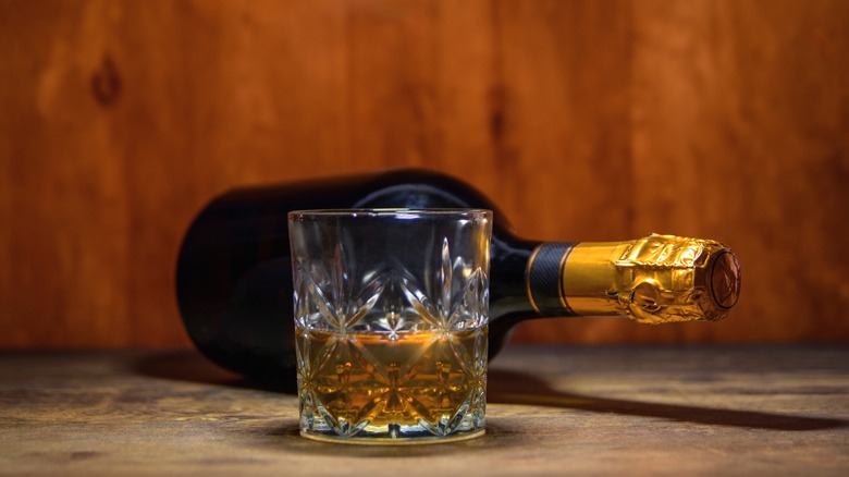 Bottle of champagne and glass of whiskey