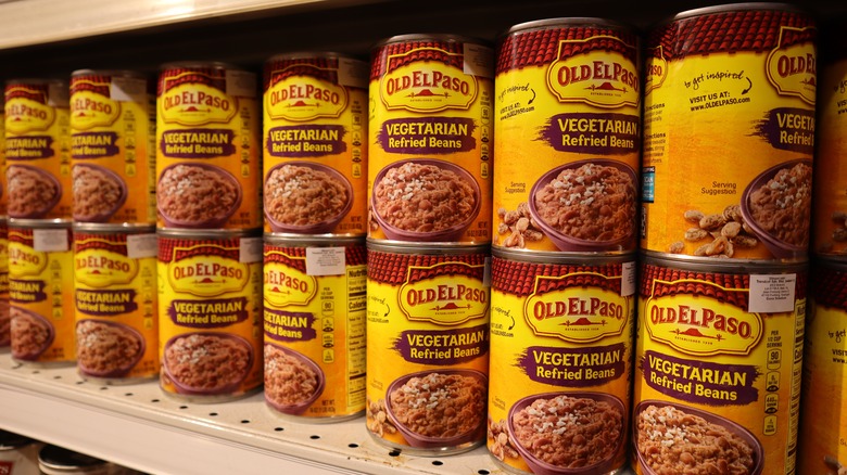 shelf of canned refried beans