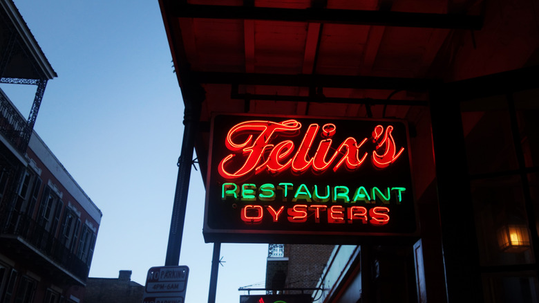 Felix's restaurant neon sign outside of establishment as sun sets.
