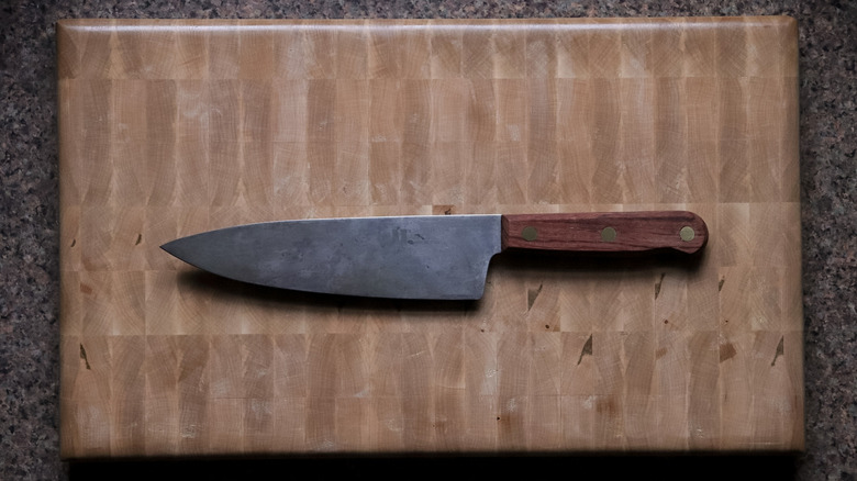 Carbon steel knife on wood cutting board
