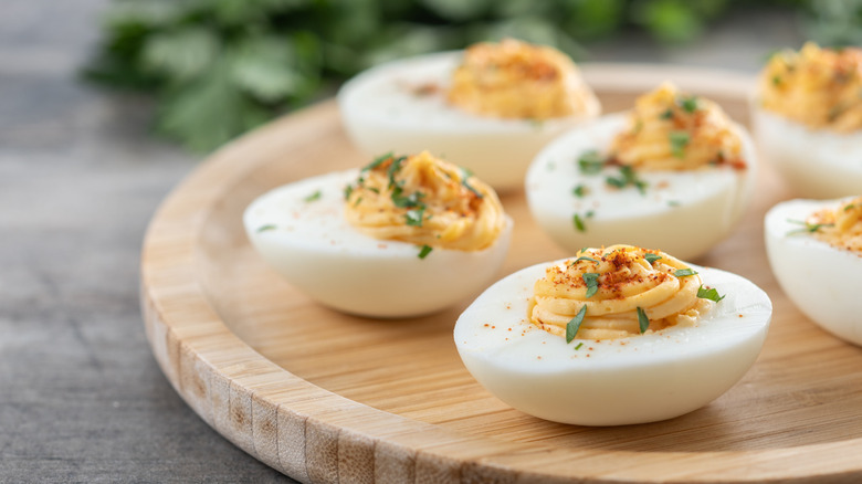 Deviled eggs on a wooden tray