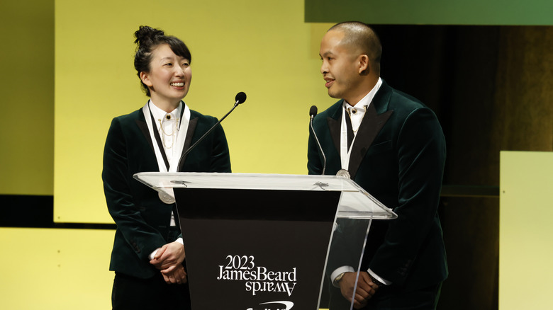Kasama owners Genie Kwon and Timothy Flores stand at a podium at the James Beard Awards.