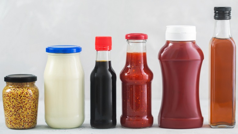 Row of jars in order of height: mustard, mayo, soy sauce, chile garlic sauce, ketchup, ACV.