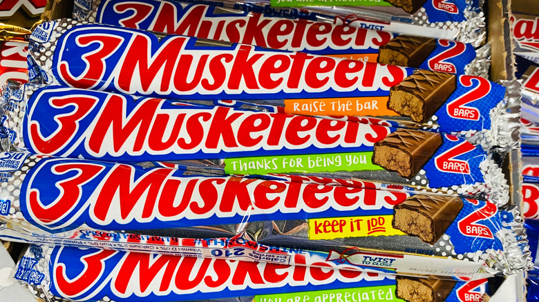 A box of 3 Musketeers bars in their shiny silver wrappers.