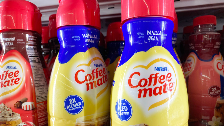 Various coffee creamers on grocery store shelf.
