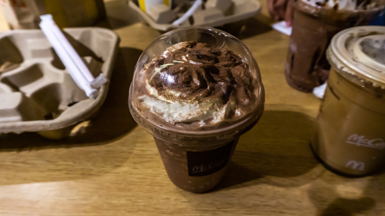 A chocolate McDonald's frappé in a plastic cup