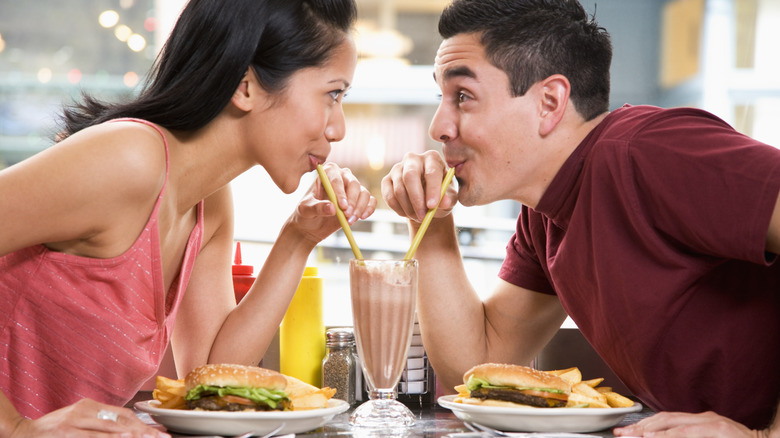 Two people sharing a malt 