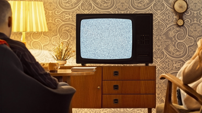 an old wooden TV console with drawers and cabinets