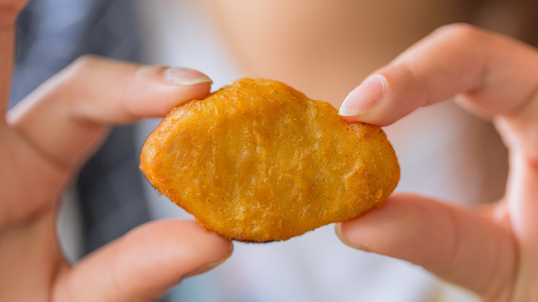 hands holding a McNugget