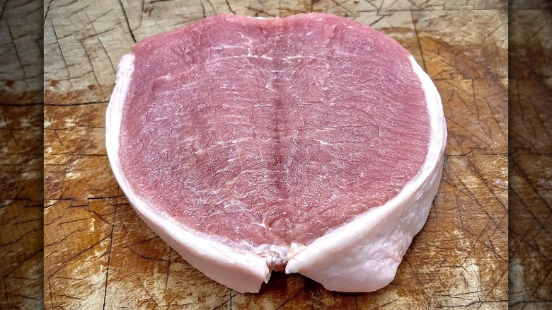 Pork chop being butterflied.