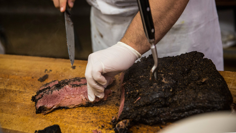 Close-up of a meat cutter slicing pastrami at Katz's Deli