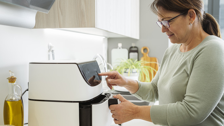 Woman using an air fryer