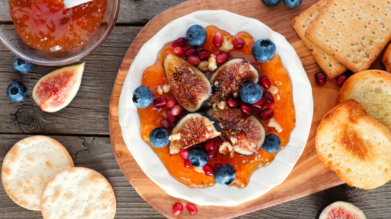 Baked brie with fruit and nuts.