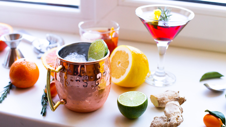 Cocktails and ingredients by a window