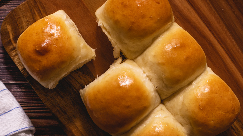 Homemade dinner rolls on a wooden board