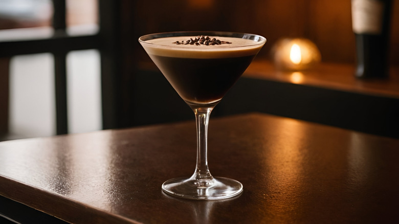 An espresso martini on a dark wood bar