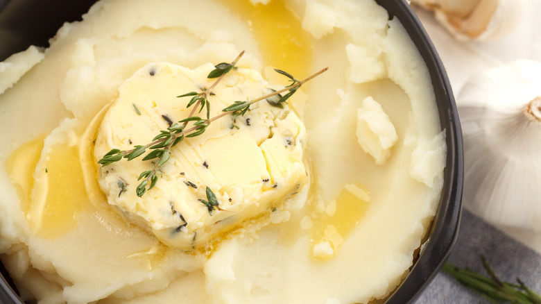 Garlic butter with herbs on top of mashed potatoes.