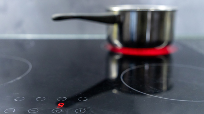 Blurred pot sitting on an induction cooktop