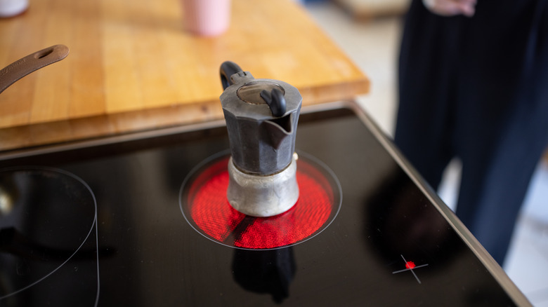 Moka pot on an electric stove in the kitchen