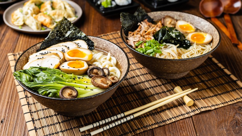 Two bowls of ramen with dumplings