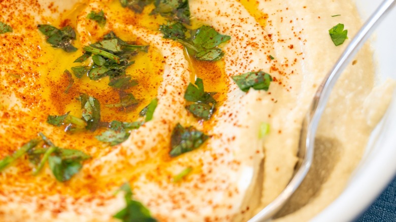 Bowl of hummus with herbs