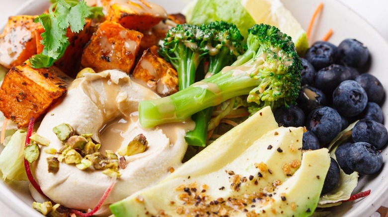 Salad and veggies with hummus dressing