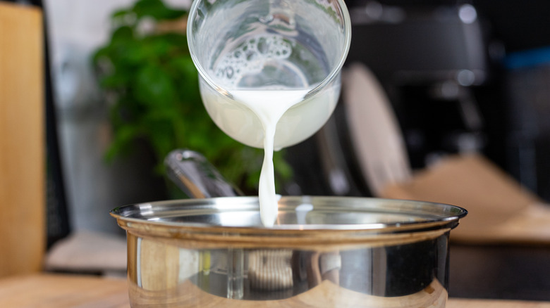 Pouring milk into pot