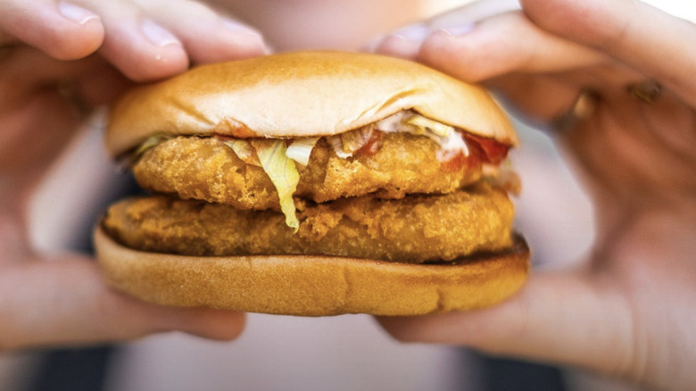 hand holds the McDeal Poulet
