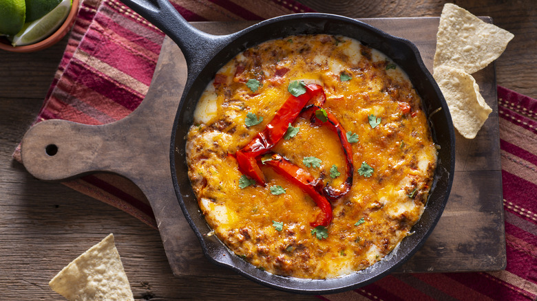 Queso fundido with chorizo in a cast iron skillet