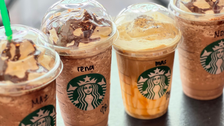 Several Starbucks Frappuccino drinks lined up