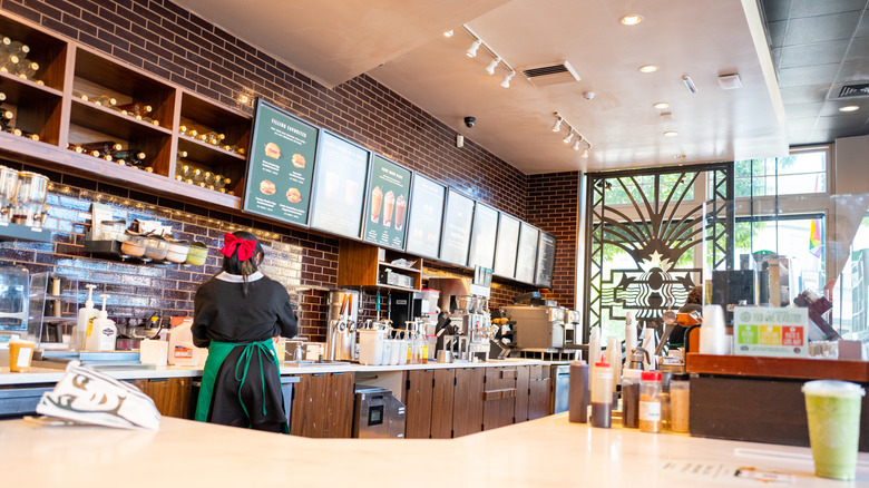 Starbucks employee making drinks behind the counter